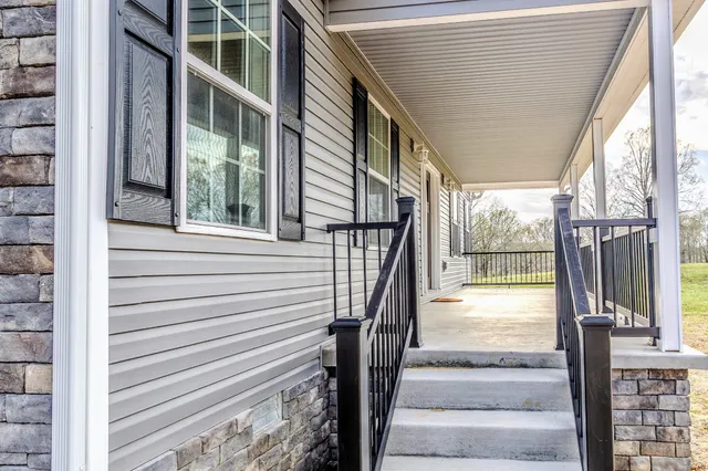 a view of balcony with wooden floor and fence