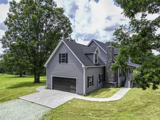 a front view of house with yard and green space