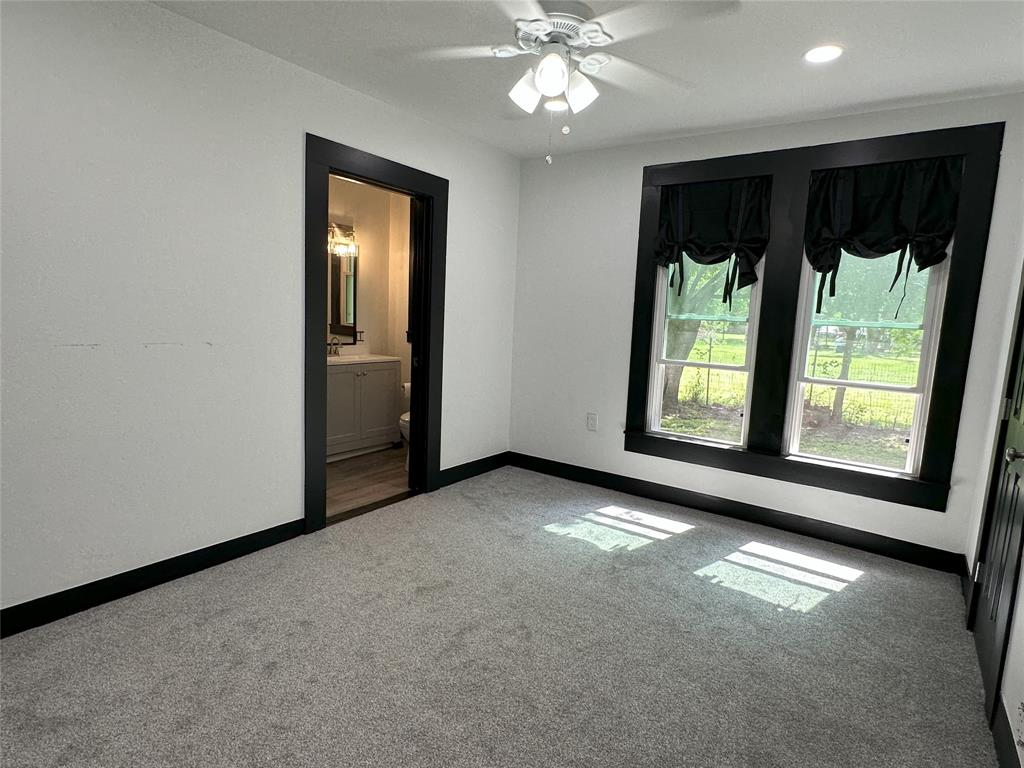 506 Northeast 3rd Street Hubbard, TX 76648 - Photo 13 of 17 an empty room with windows and entrance