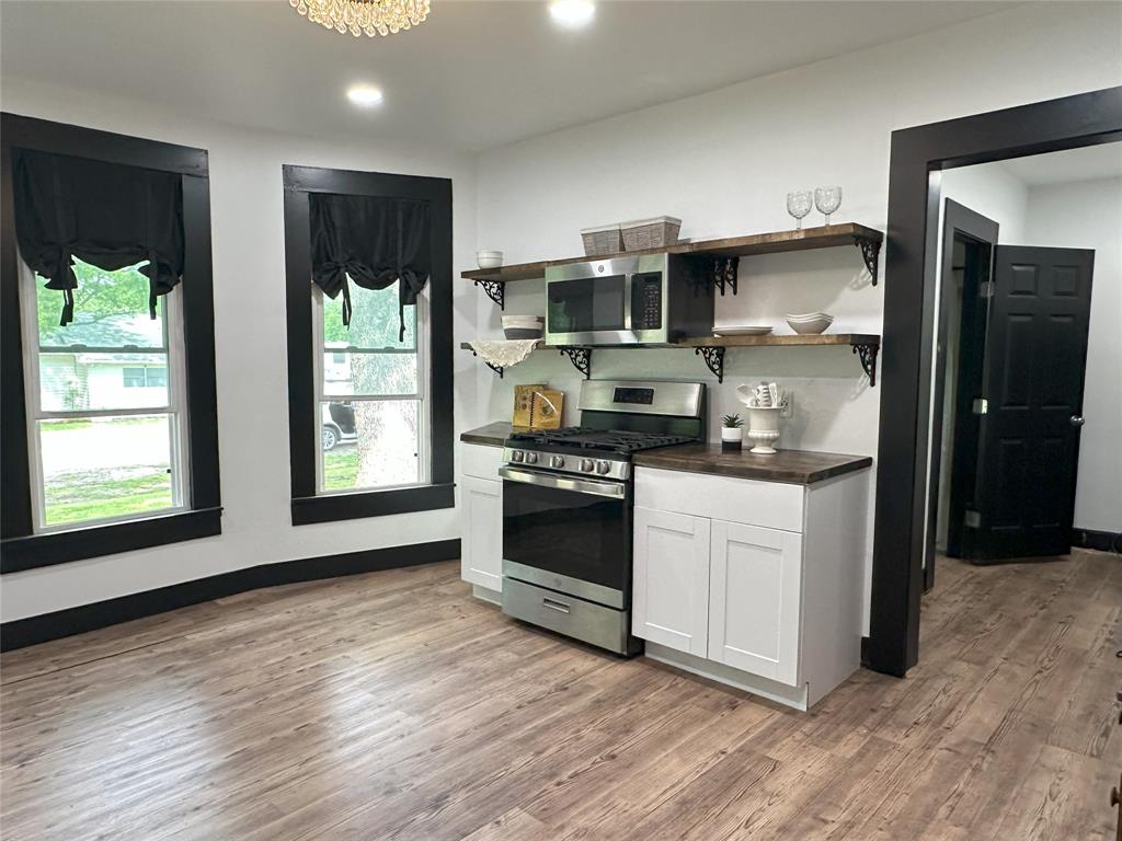 506 Northeast 3rd Street Hubbard, TX 76648 - Photo 7 of 17 a kitchen with stainless steel appliances a stove a sink and a refrigerator