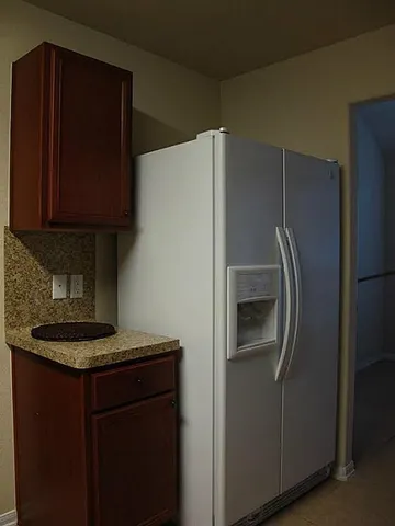 a kitchen with a refrigerator and a sink
