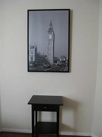 a view of a hallway with paintings on the wall
