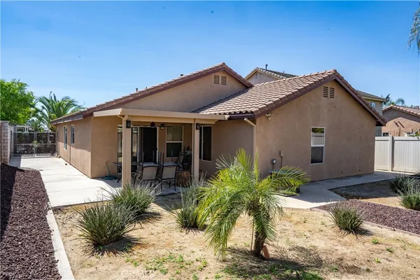 a front view of house with yard and seating space