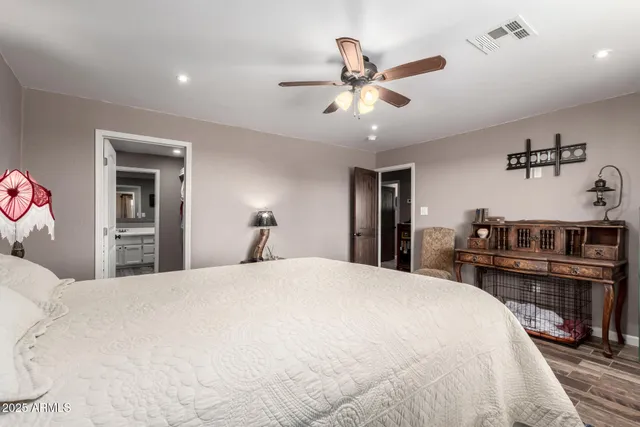a bedroom with a large bed and a chandelier