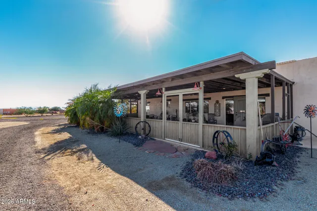 a view of a house with backyard porch and sitting area