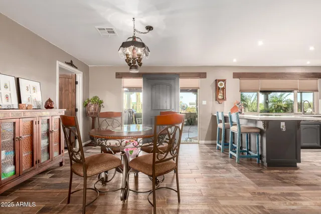 a view of a dining room with furniture and chandelier