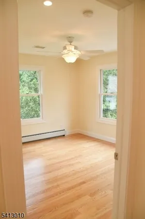 a view of a room with wooden floor and a window