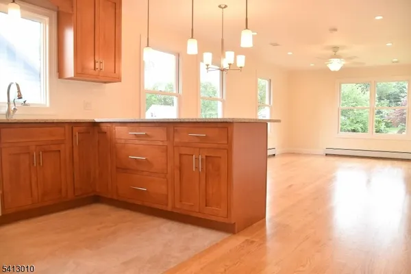 a bathroom with a sink a window and a shower