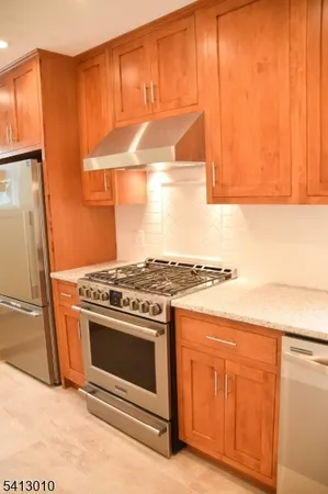 a stove top oven sitting inside of a kitchen