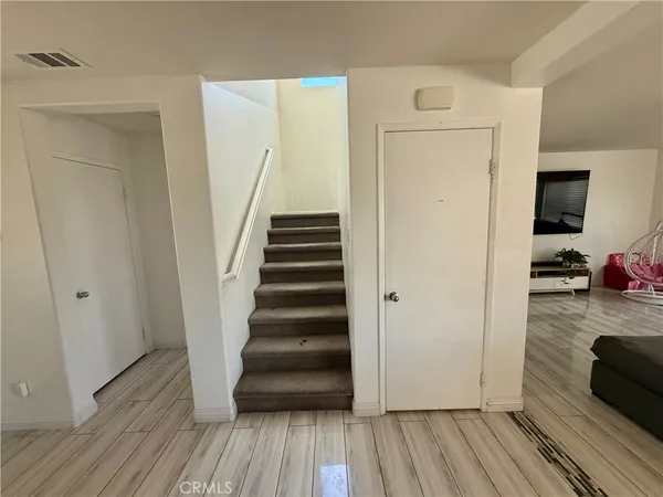a view of a hallway view with wooden floor and staircase