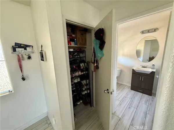 a view of walk in closet with clothes and shoes