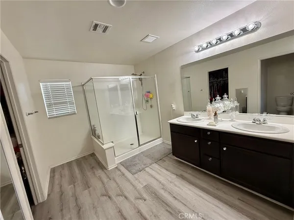a spacious bathroom with a double vanity sink and a mirror
