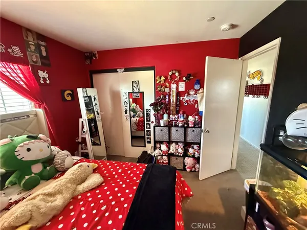 a bedroom with furniture and wooden floor
