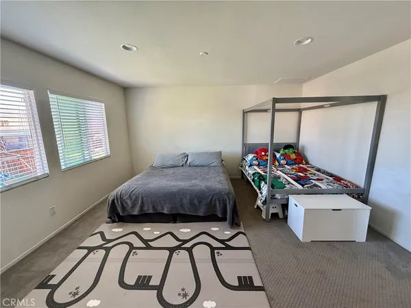 a bedroom with bed and a window