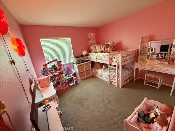 a bedroom with furniture and a wooden floor