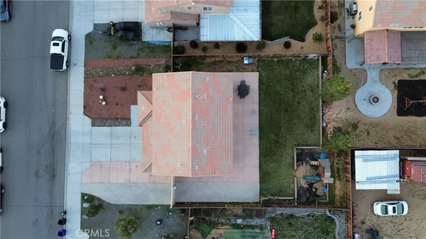 an aerial view of a house with a yard and a fountain