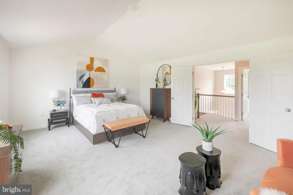 a bedroom with furniture and a potted plant