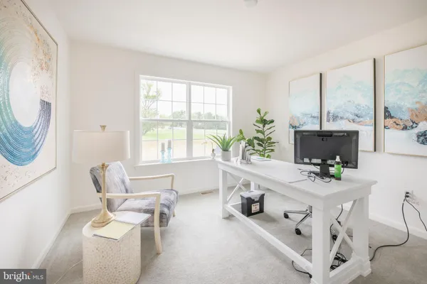 a living room with furniture a fireplace and a floor to ceiling window
