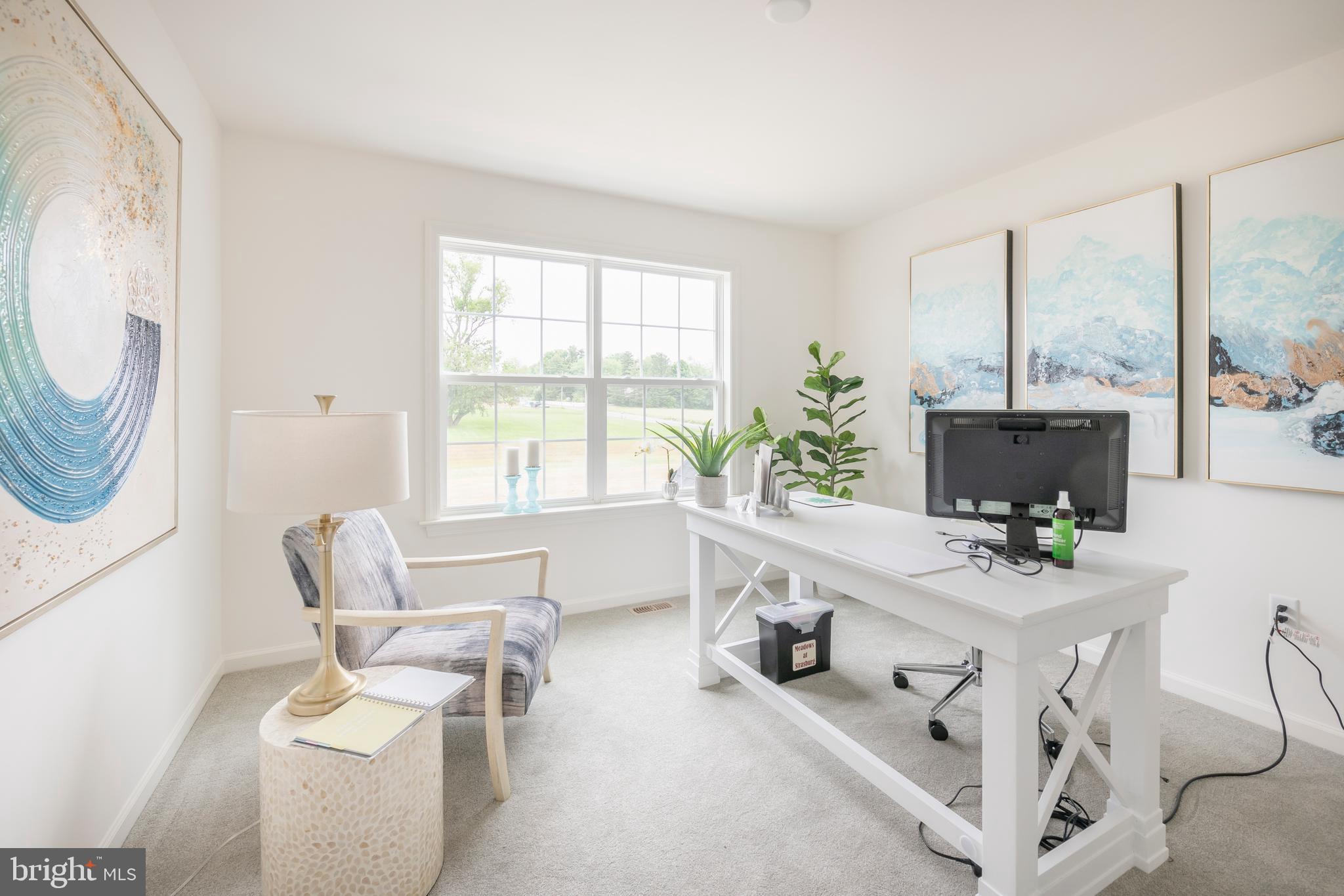 4 Old Orch Road Strasburg, PA 17579 - Photo 20 of 25 a living room with furniture a fireplace and a floor to ceiling window