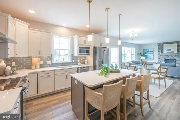 a large kitchen with a table and chairs