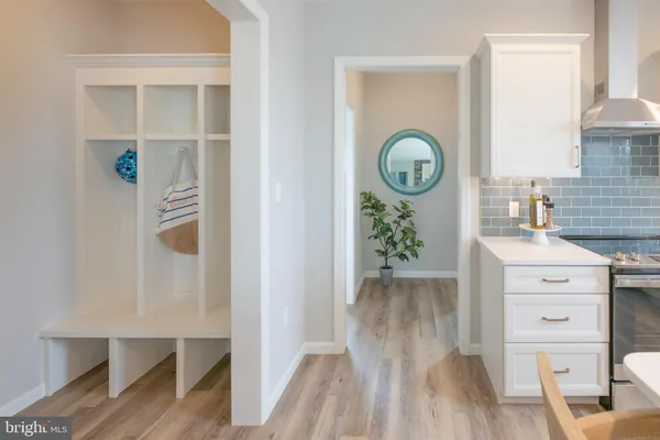 a view of a hallway to closet and wooden floor