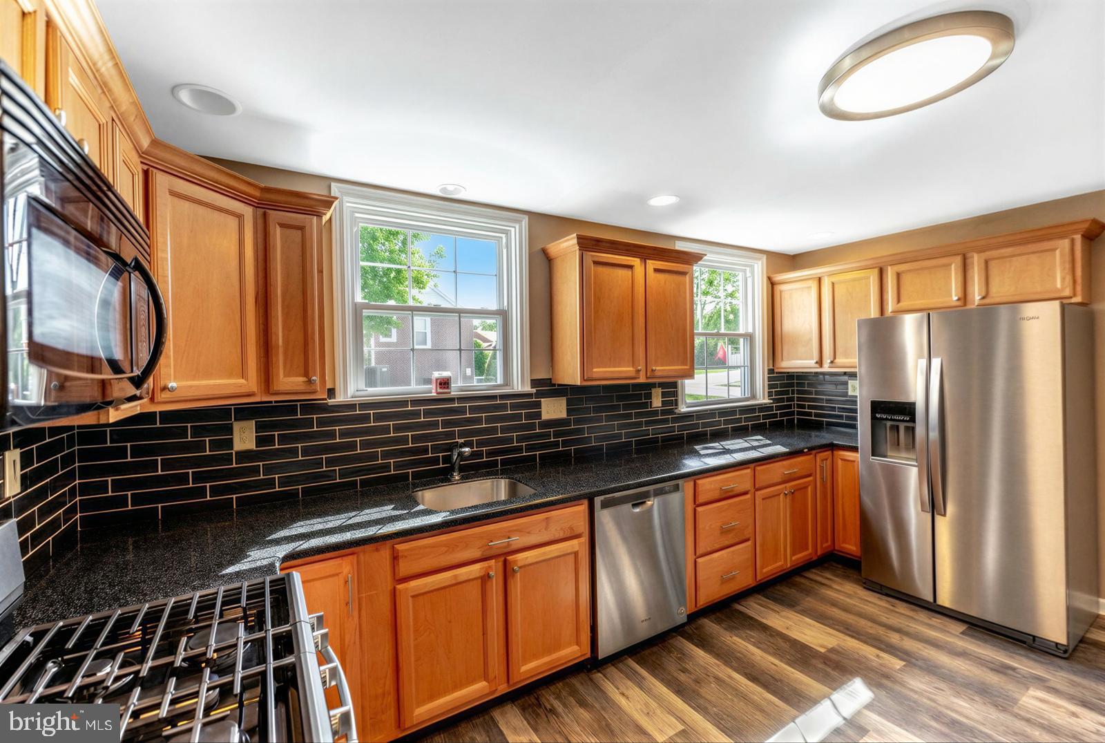 107 Valley View Road Norristown, PA 19401 - Photo 12 of 35 a kitchen with stainless steel appliances granite countertop a stove a sink and a refrigerator
