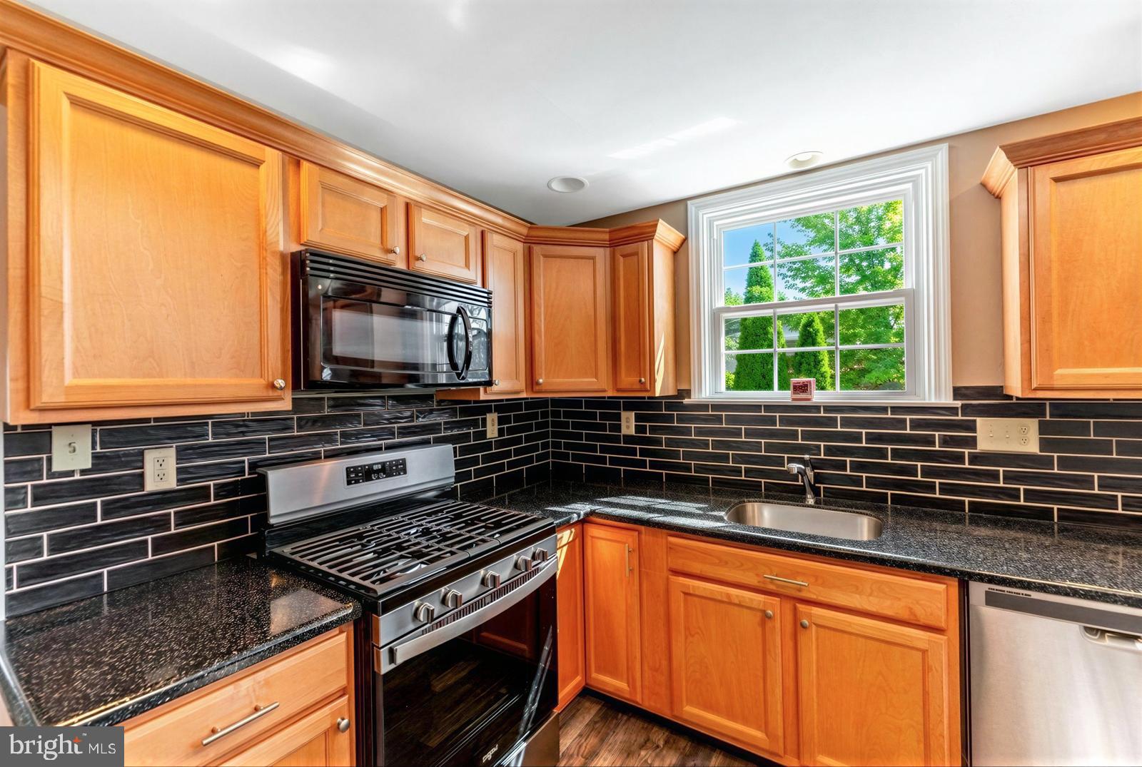 107 Valley View Road Norristown, PA 19401 - Photo 14 of 35 a kitchen with granite countertop a stove sink and microwave
