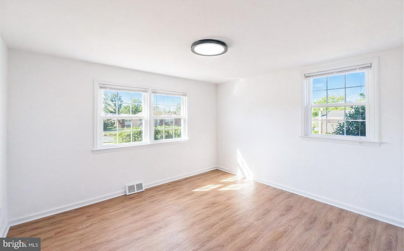 107 Valley View Road Norristown, PA 19401 - Photo 19 of 35 an empty room with wooden floor and windows