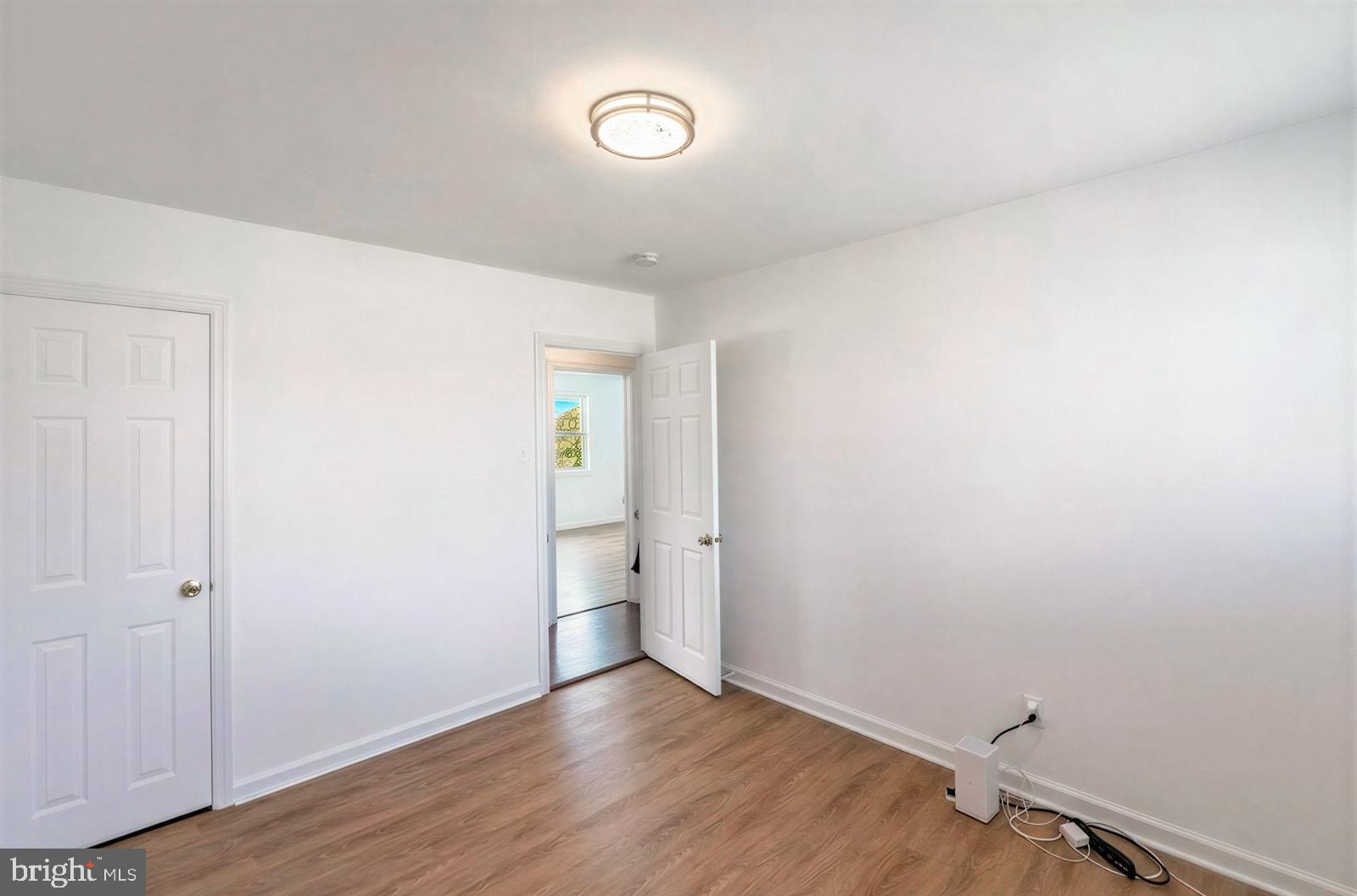 107 Valley View Road Norristown, PA 19401 - Photo 24 of 35 an empty room with wooden floor and windows