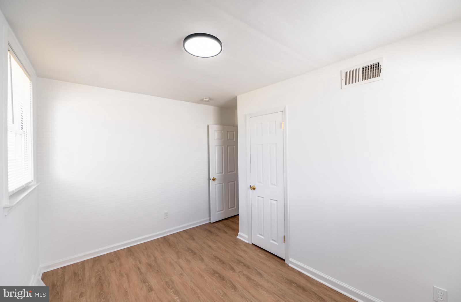 107 Valley View Road Norristown, PA 19401 - Photo 26 of 35 an empty room with wooden floor and windows