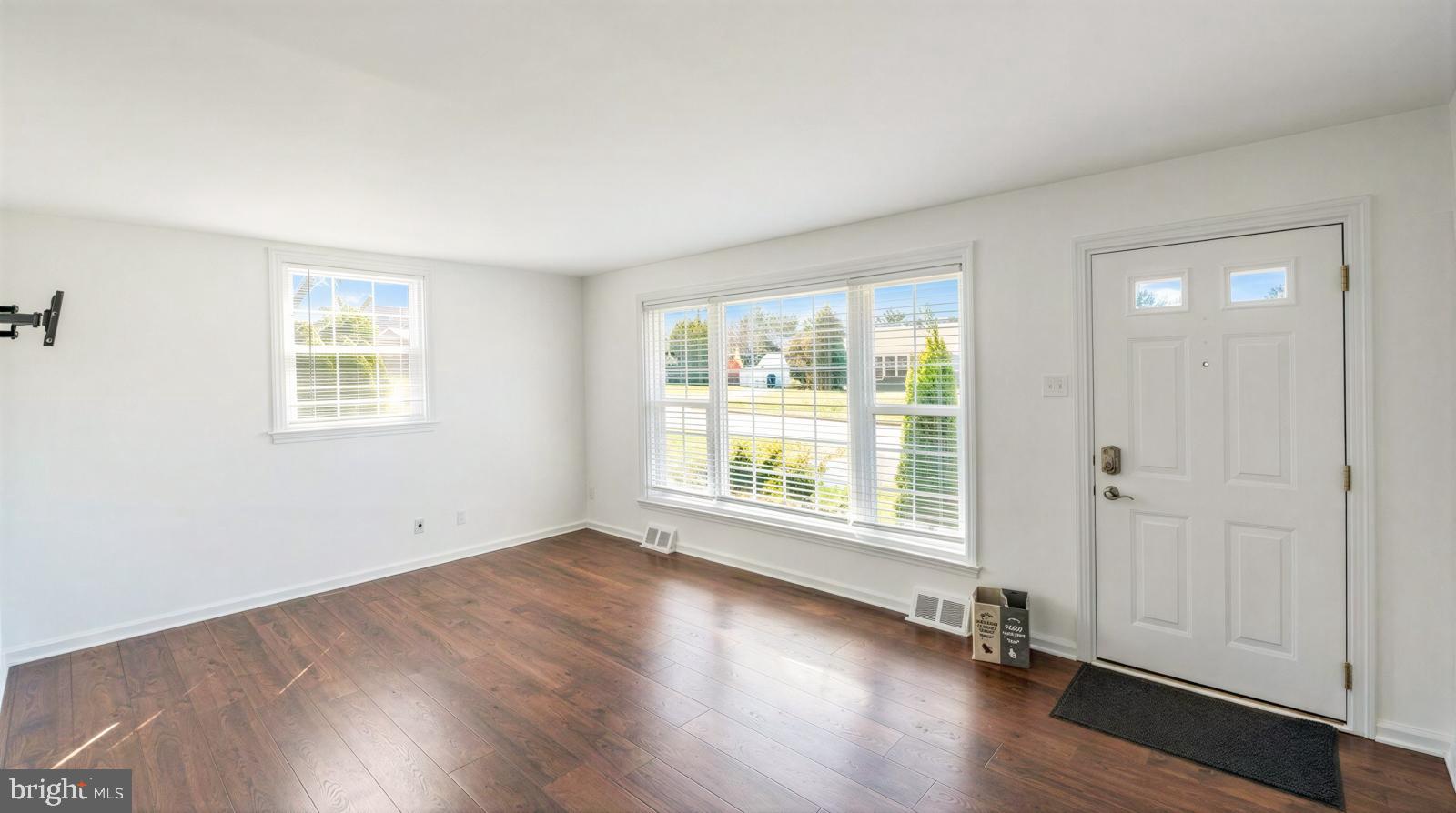 107 Valley View Road Norristown, PA 19401 - Photo 7 of 35 an empty room with wooden floor and windows