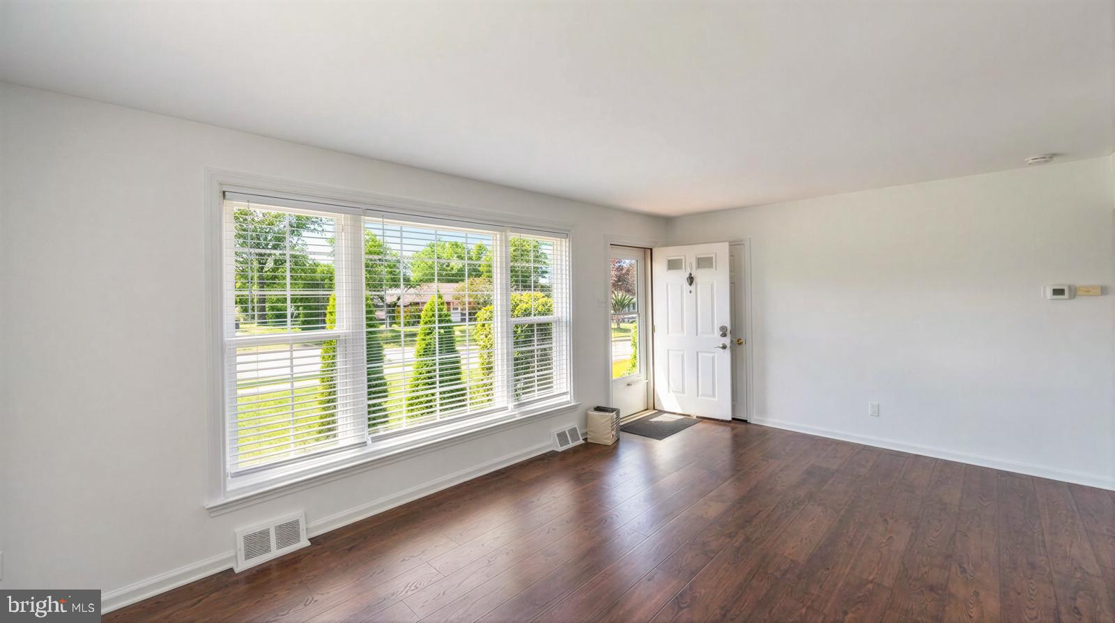 107 Valley View Road Norristown, PA 19401 - Photo 8 of 35 a view of an empty room with wooden floor and a window