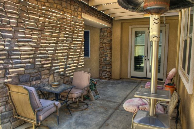 a view of a chair and fire pit in backyard