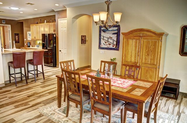 a view of a dining room with furniture and chandelier