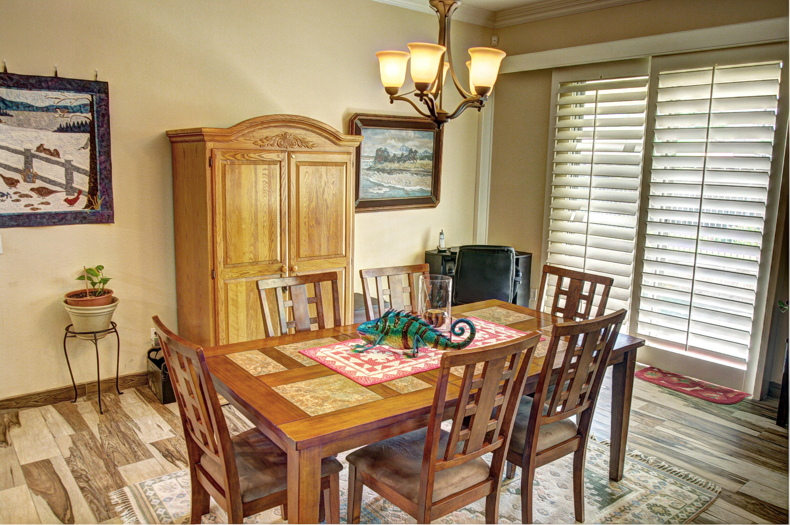 49714 Newman Circle Indio, CA 92201 - Photo 18 of 42 a view of a dining room with furniture wooden floor and chandelier