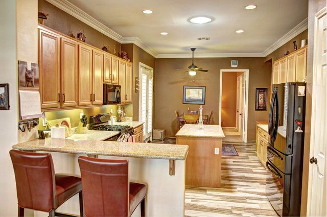 a large kitchen with a large window and stainless steel appliances