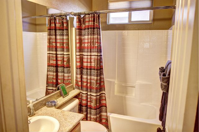 a bathroom with a shower curtain and a sink