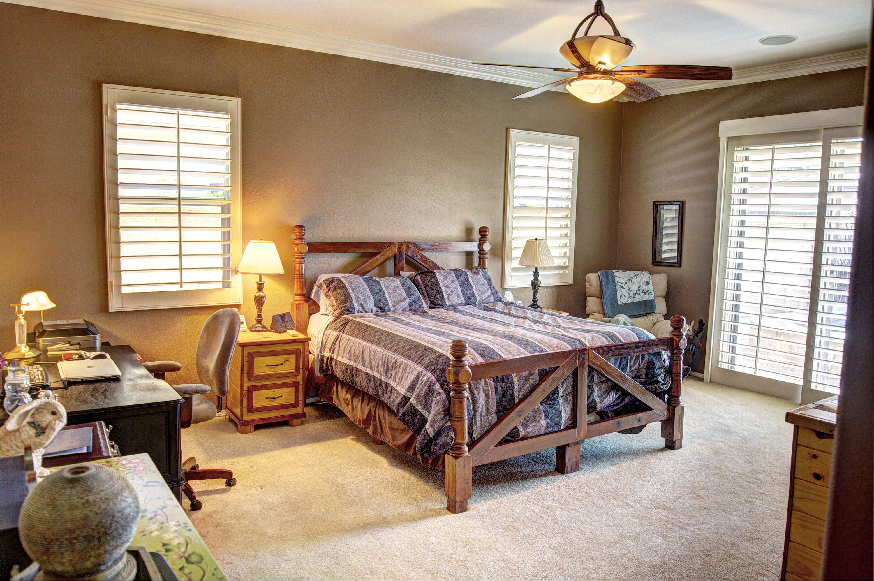 49714 Newman Circle Indio, CA 92201 - Photo 26 of 42 a bedroom with a bed and a chandelier