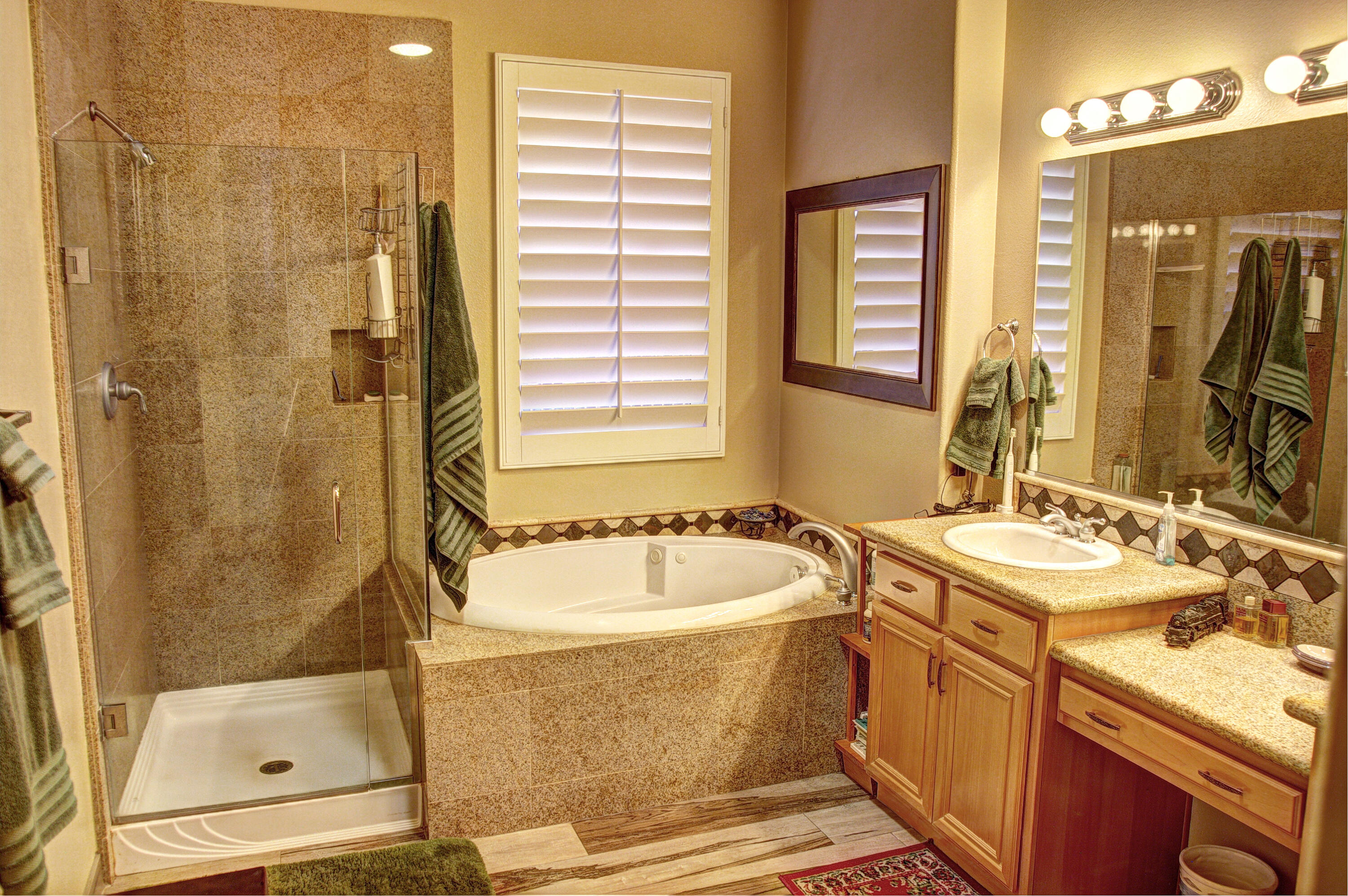 49714 Newman Circle Indio, CA 92201 - Photo 28 of 42 a bathroom with a tub sink shower and mirror