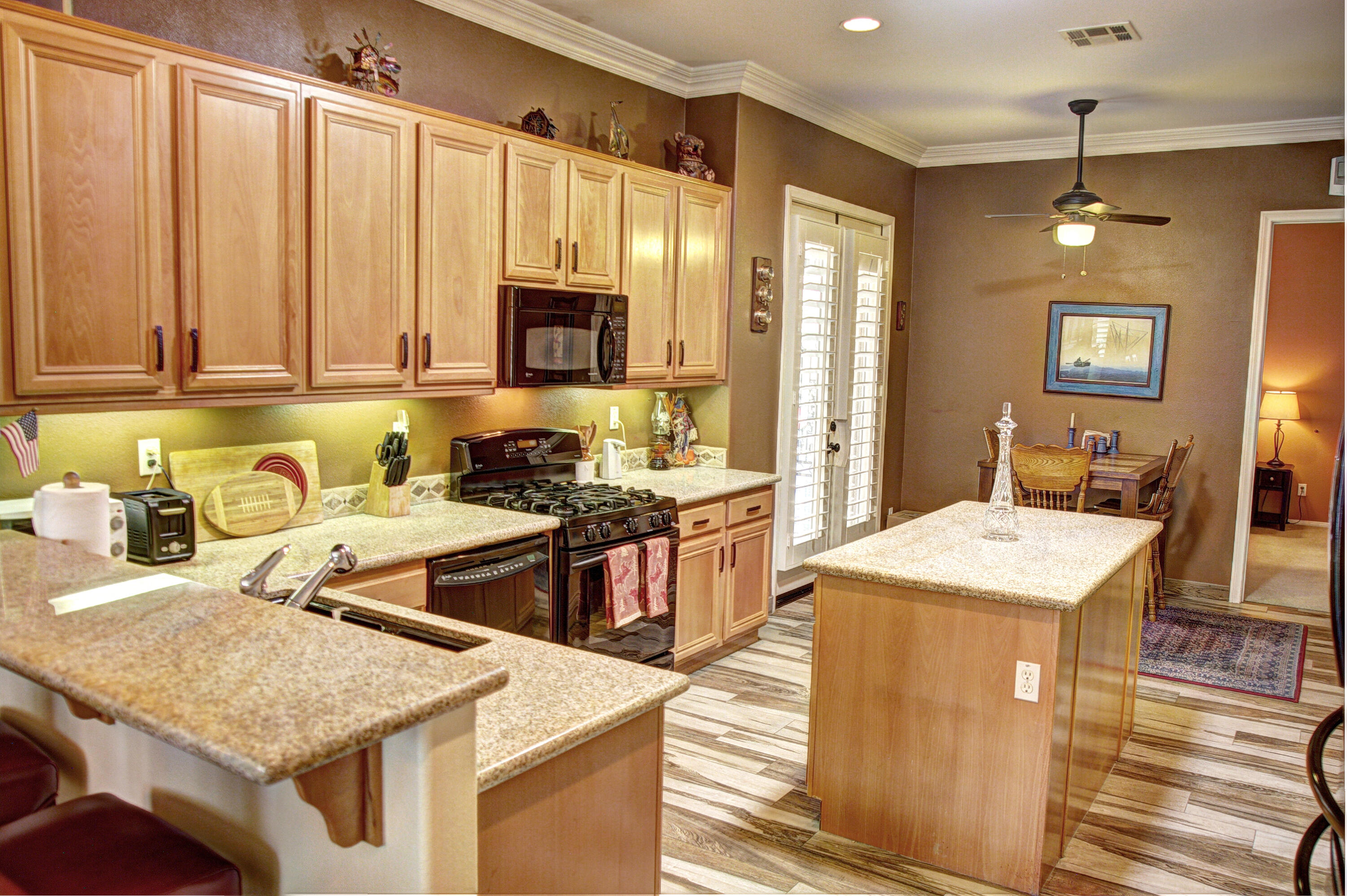 49714 Newman Circle Indio, CA 92201 - Photo 3 of 42 a kitchen with stainless steel appliances granite countertop a sink stove and refrigerator