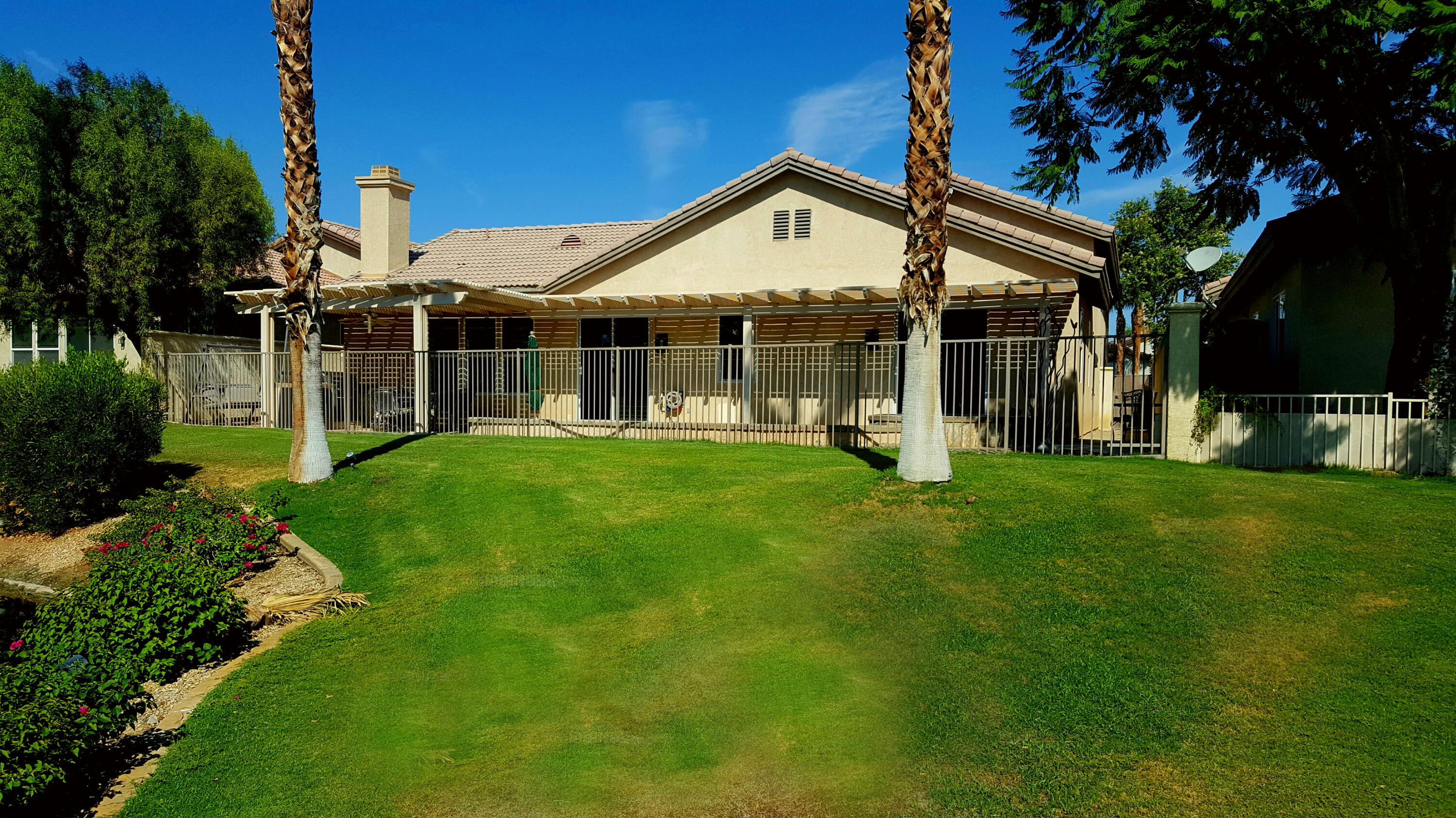 49714 Newman Circle Indio, CA 92201 - Photo 35 of 42 a front view of a house with a yard and porch