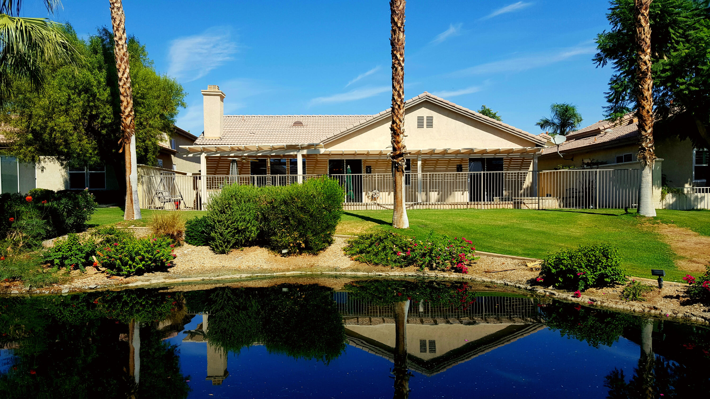 49714 Newman Circle Indio, CA 92201 - Photo 36 of 42 a backyard of a house with yard table and chairs