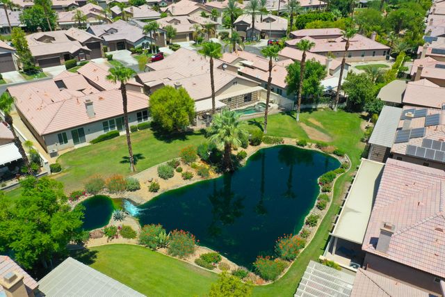 an aerial view of a house with a garden and lots of trees
