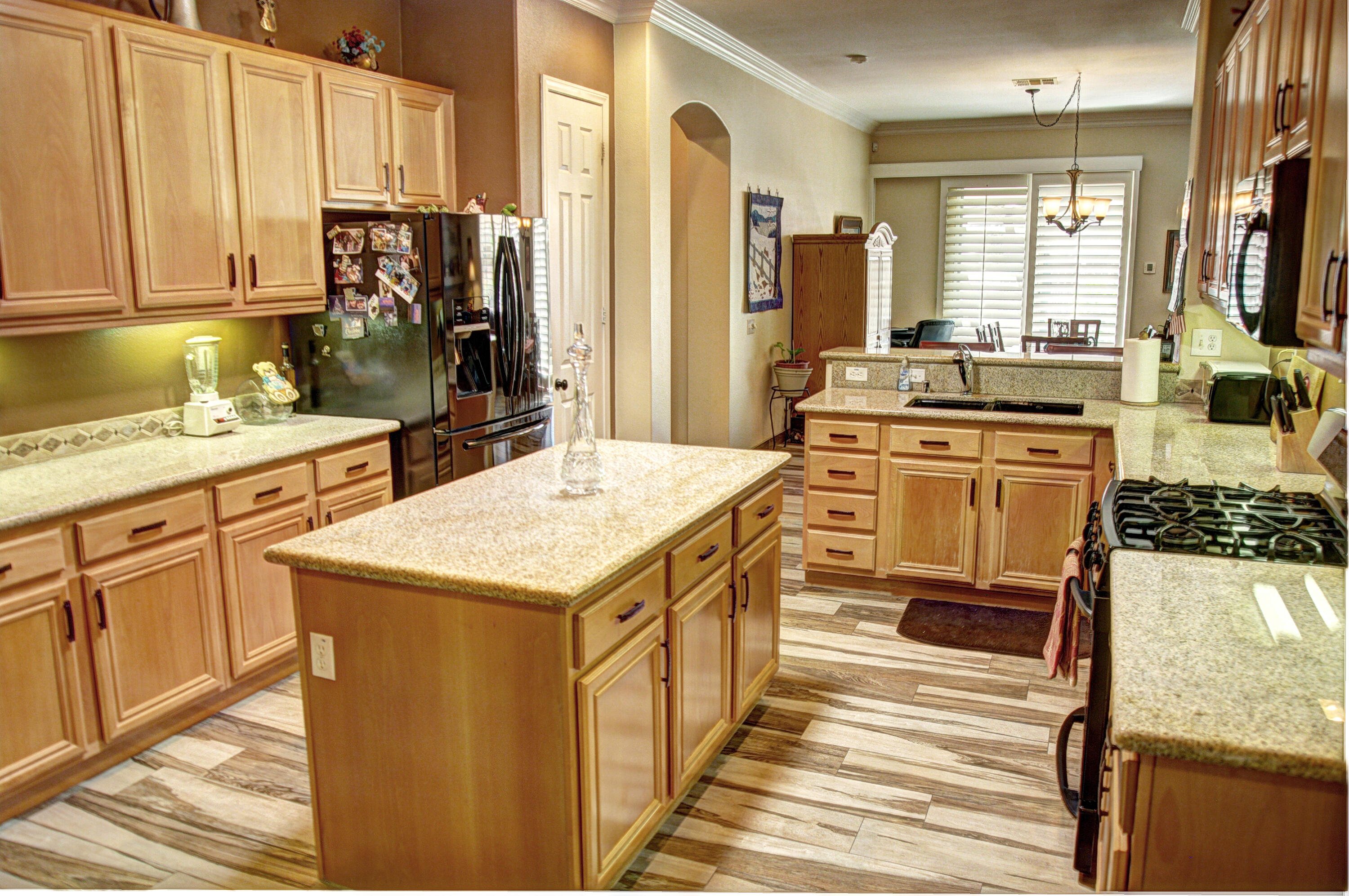49714 Newman Circle Indio, CA 92201 - Photo 7 of 42 a kitchen with a stove a sink a refrigerator and cabinets