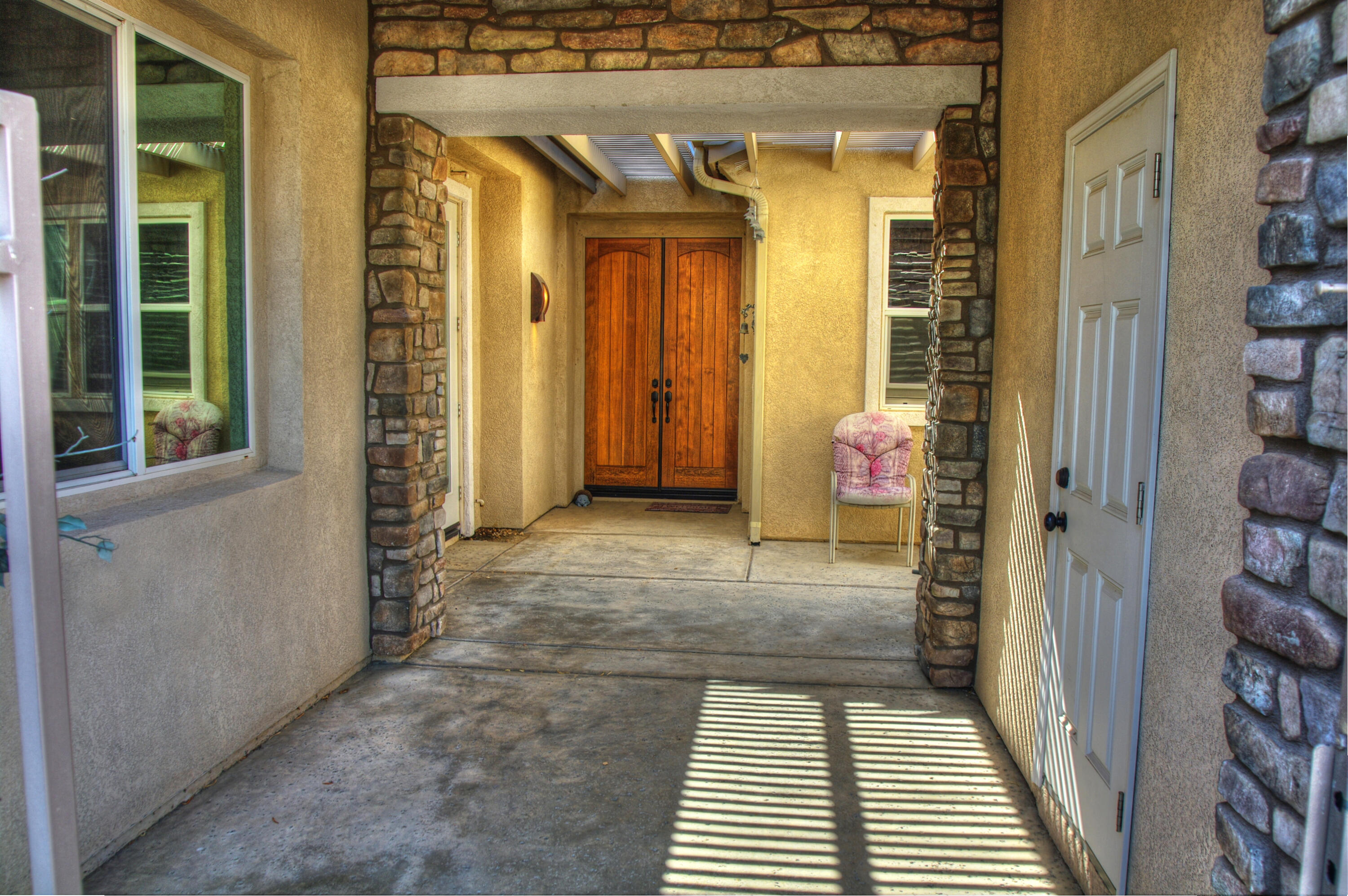 49714 Newman Circle Indio, CA 92201 - Photo 10 of 42 a view of a hallway with wooden door
