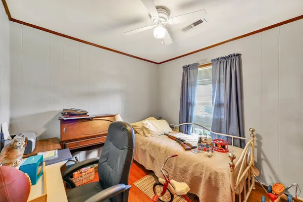 a bedroom with furniture and a chandelier