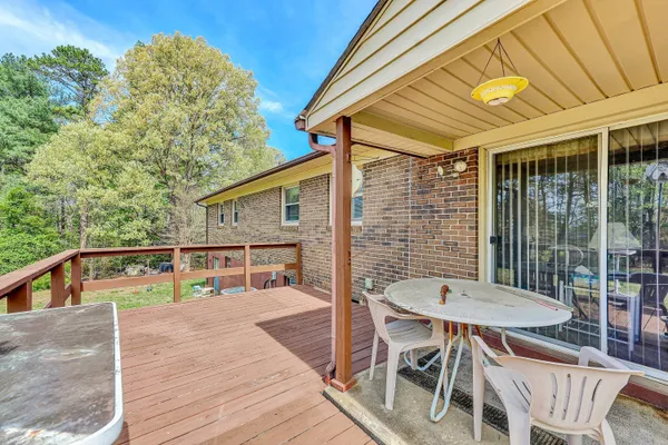 a view of a balcony with wooden floor and fence