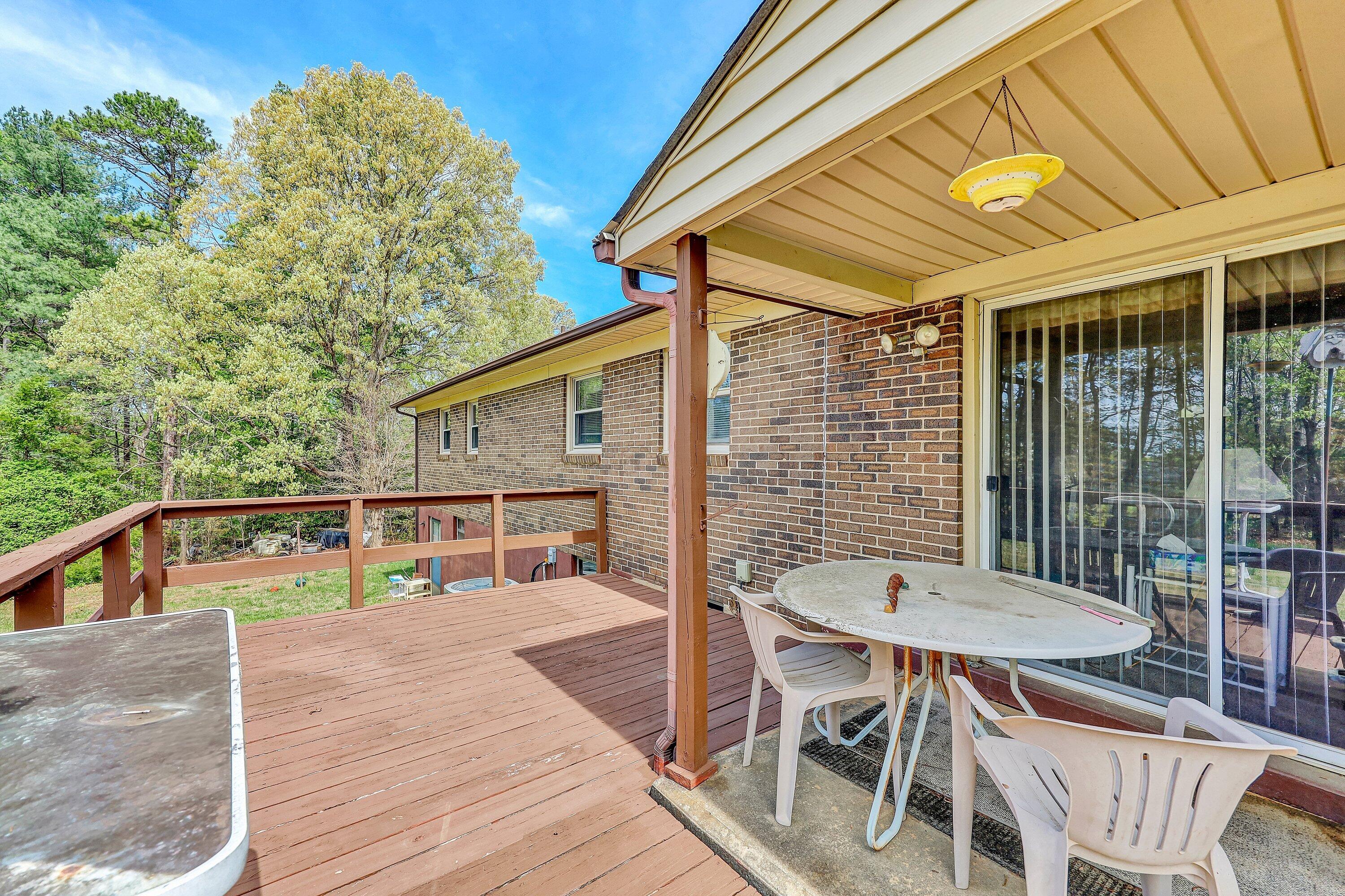 509 Carver Road Martinsville, VA 24112 - Photo 21 of 25 a view of a patio with table and chairs with wooden floor and fence