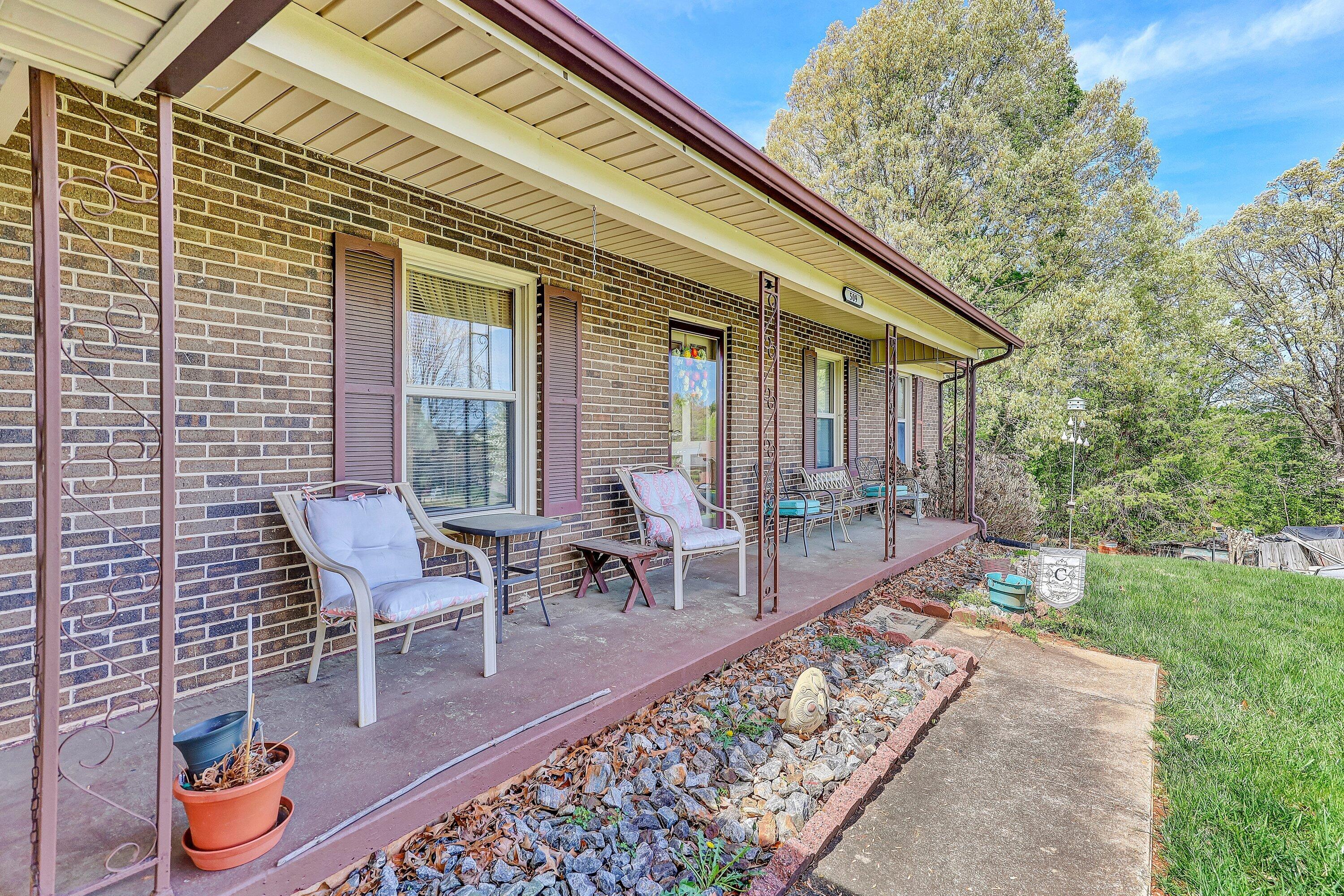 509 Carver Road Martinsville, VA 24112 - Photo 4 of 25 a view of a patio with table and chairs and potted plants