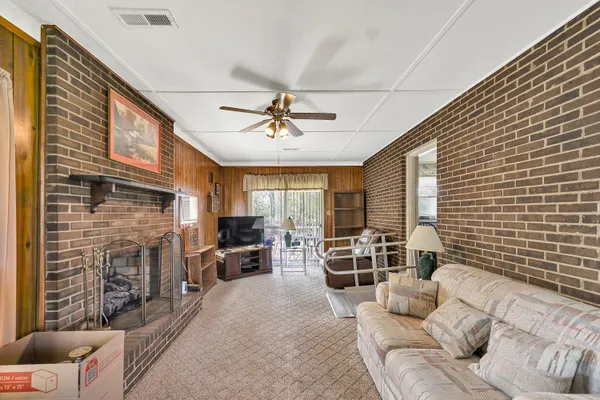 a living room with furniture flat screen tv and a fireplace